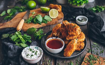 Crispy chicken wings with honey barbecue sauce and yogurt and mint sauce